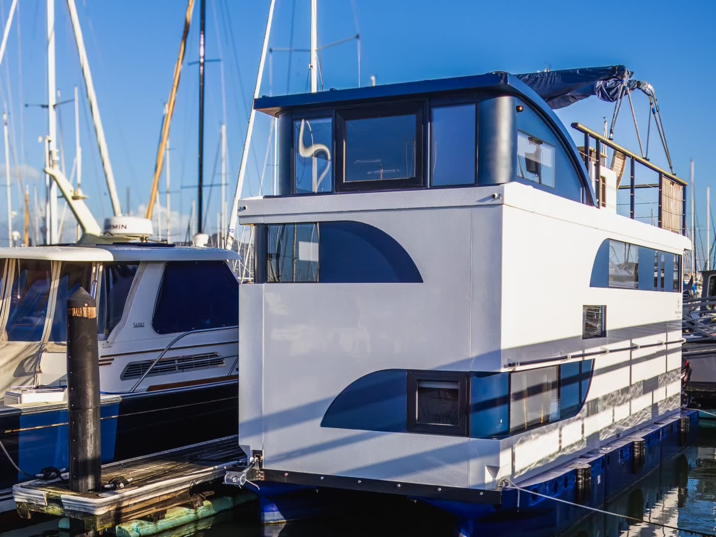 Houseboats moored at a marina dock on a calm lake